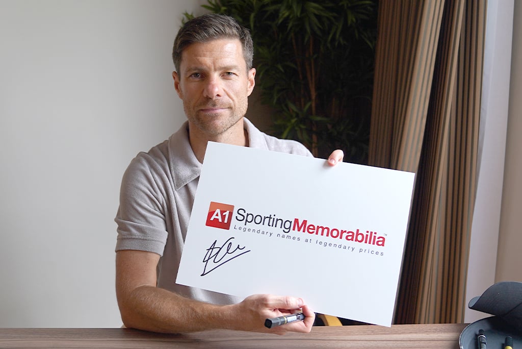 Xabi Alonso signs for A1 Sporting Memorabilia on 14th August 2024 in Leverkusen, Germany.